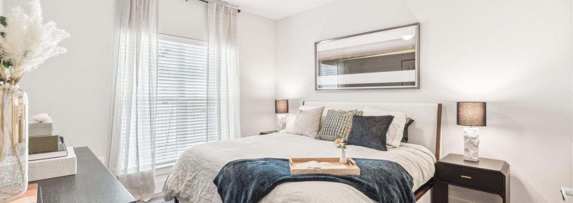 a bedroom with a ceiling fan and white bed at The Rushcreek