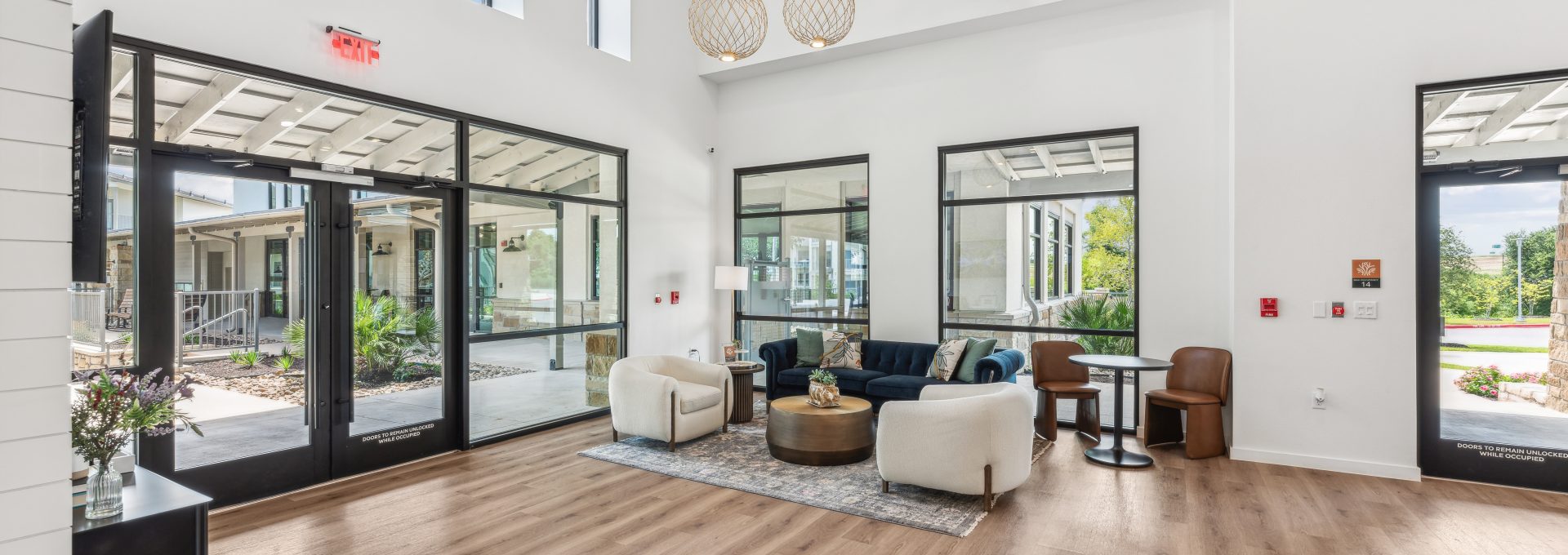 the large open living room has hardwood floors and large windows at The Rushcreek