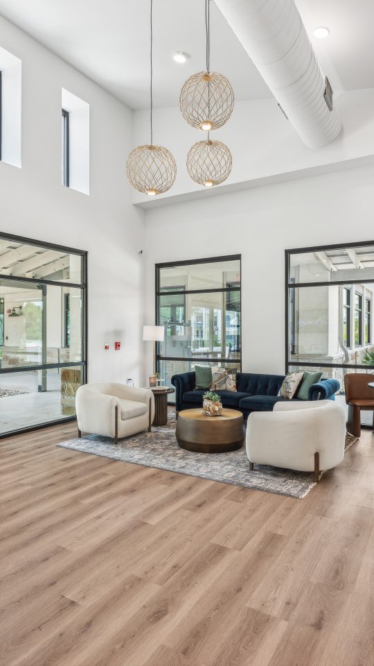 the large open living room has hardwood floors and large windows at The Rushcreek